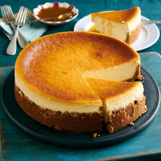Delicious homemade Maple Cheesecake topped with maple syrup.