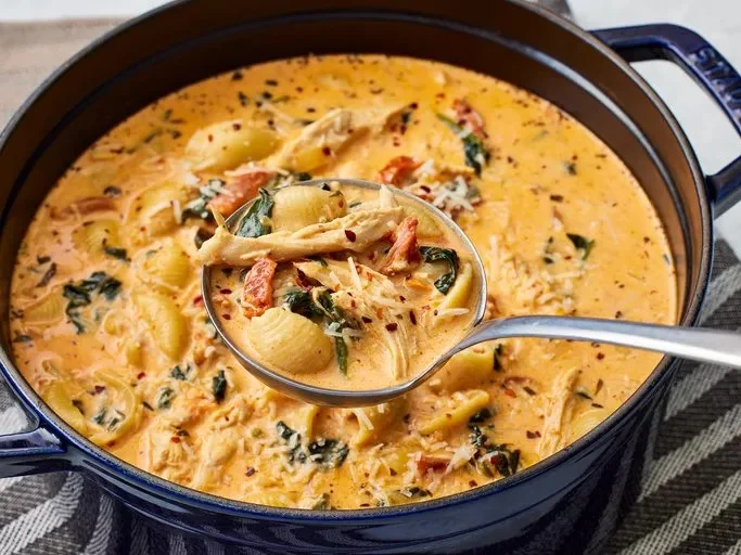 A bowl of Marry Me Chicken Soup with herbs and spices, perfect comfort food.