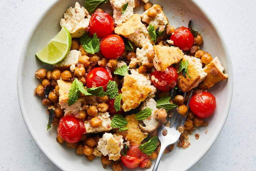 Masala chickpeas dish with tofu and blistered tomatoes on a plate