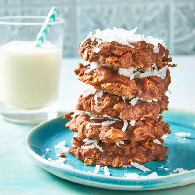 Plate of homemade no-bake chocolate oatmeal cookies with chocolate drizzle