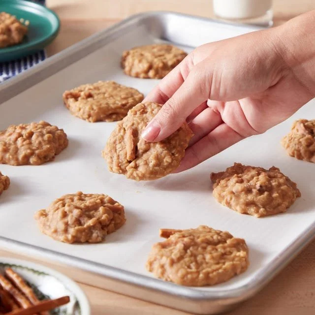 No-bake peanut butter cookies on a plate with chocolate drizzle.