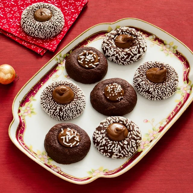 Plate of freshly baked Nutella Thumbprints cookies with rich chocolate filling