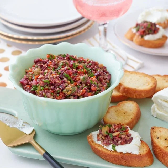 Homemade Olive Tapenade served with bread and garnish