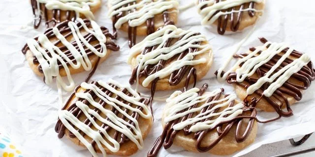 Delicious orange shortbread cookies on a white plate
