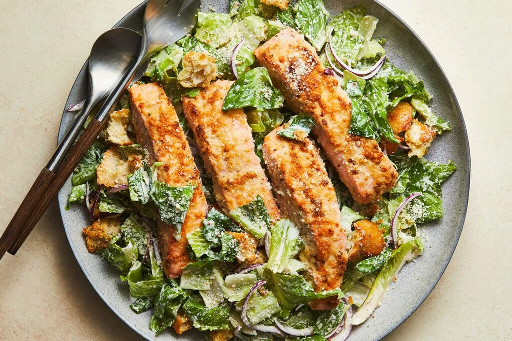 Parmesan-Crusted Salmon Caesar Salad with fresh greens and dressing