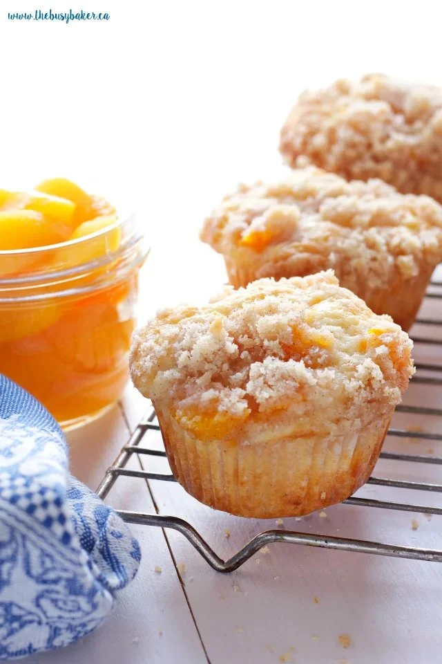 Delicious peach cobbler muffins fresh out of the oven, showcasing golden-brown tops.