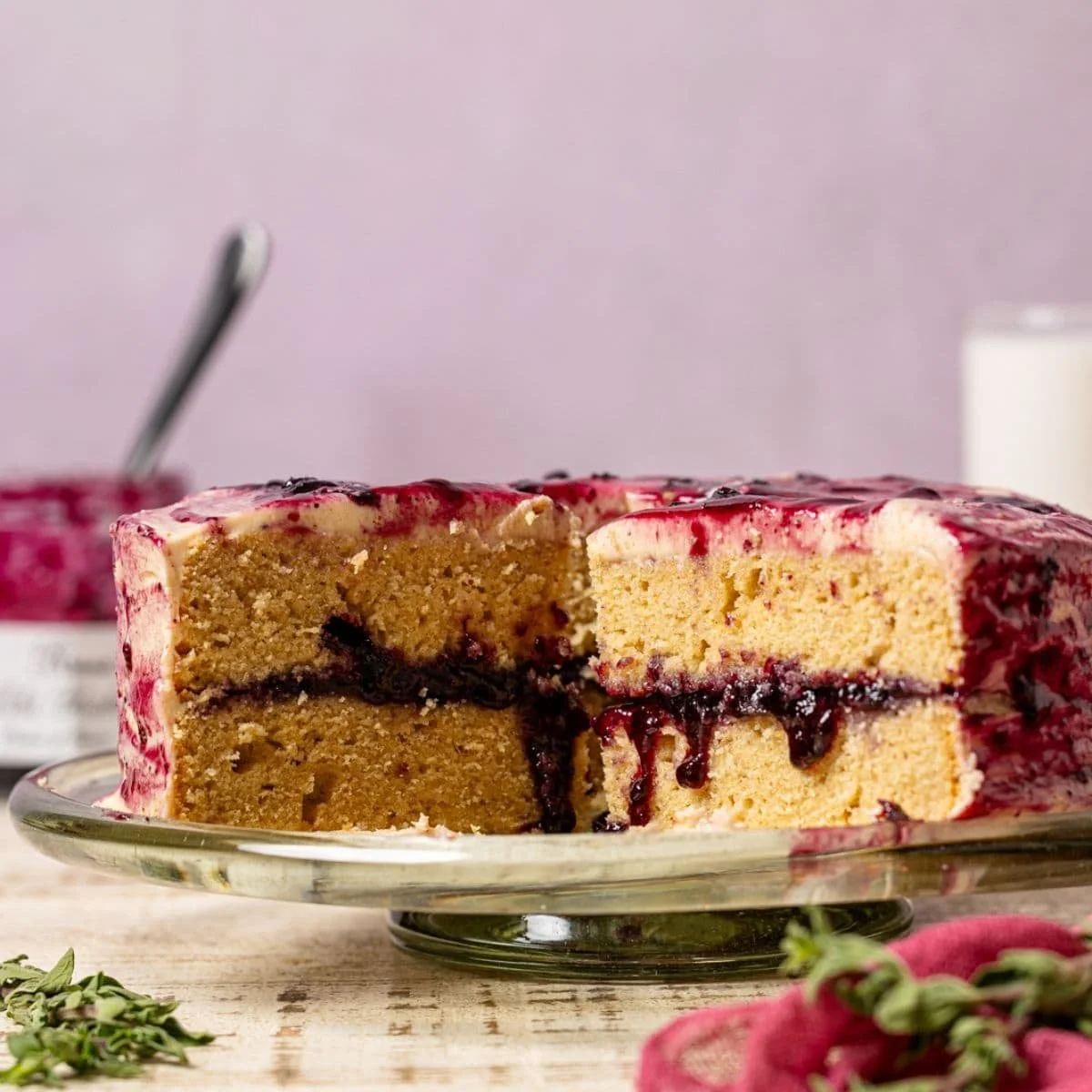Peanut Butter Jelly Cake decorated with colorful jelly and creamy frosting