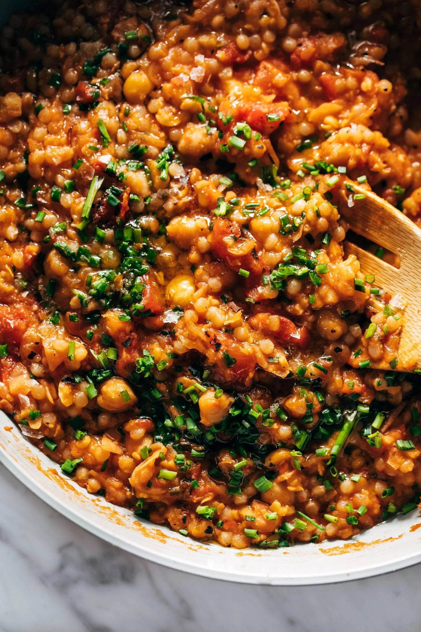 Delicious Pearl Couscous Skillet topped with fresh vegetables and herbs