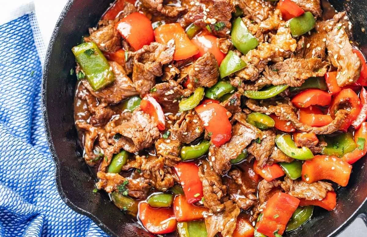 Pepper steak stir-fry with colorful vegetables served in a skillet