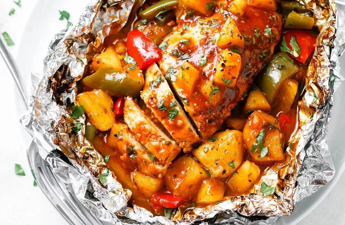 Pineapple BBQ Baked Chicken Foil Packets on a grill