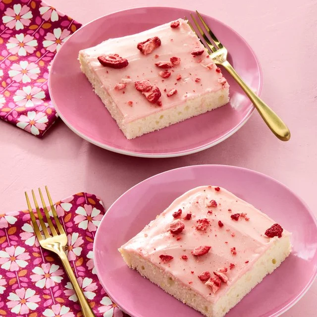 Delicious slice of Pink Lemonade Sheet Cake garnished with lemon slices