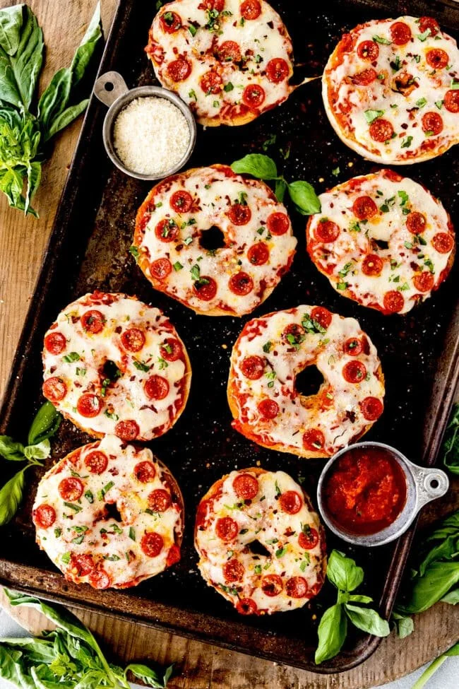 Freshly baked pizza bagels topped with cheese and pepperoni