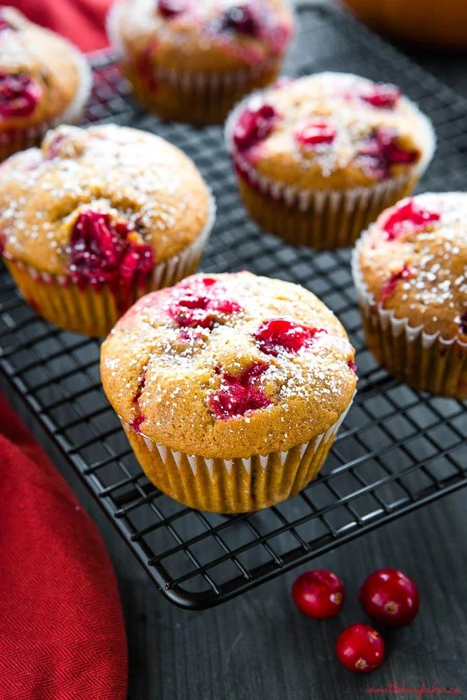 Homemade Pumpkin Cranberry Muffins fresh out of the oven with cranberries and pumpkin puree.