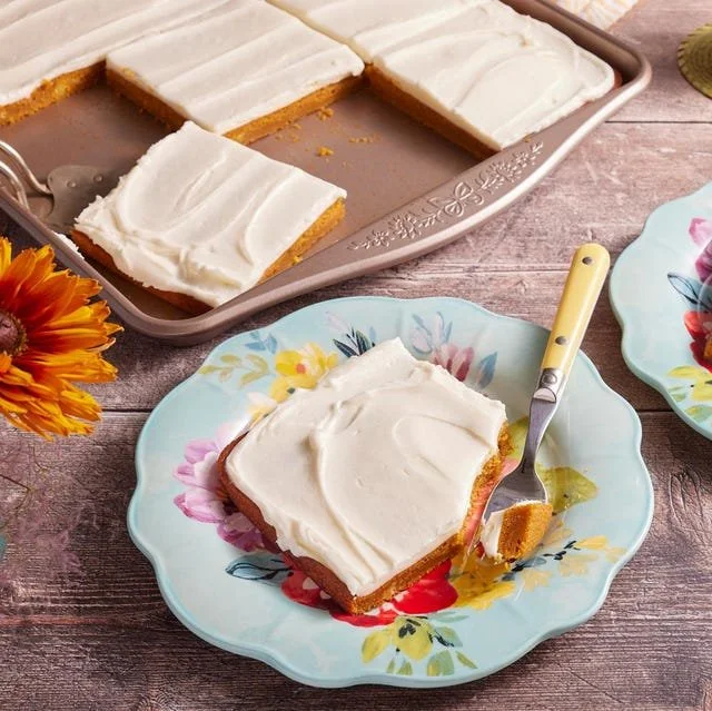Delicious Pumpkin Sheet Cake topped with creamy frosting and fall spices.