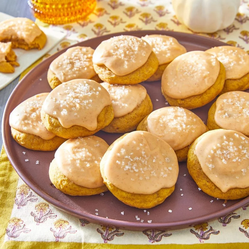 Deliciously decorated Pumpkin Sugar Cookies on a rustic wooden table