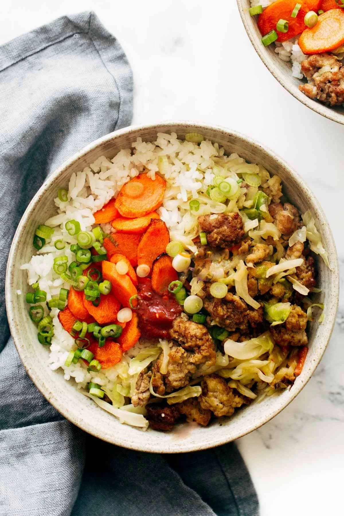 Delicious egg roll in a bowl served with fresh vegetables and soy sauce