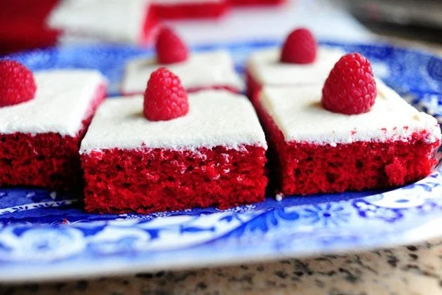Delicious red velvet sheet cake topped with creamy frosting and decorative sprinkles