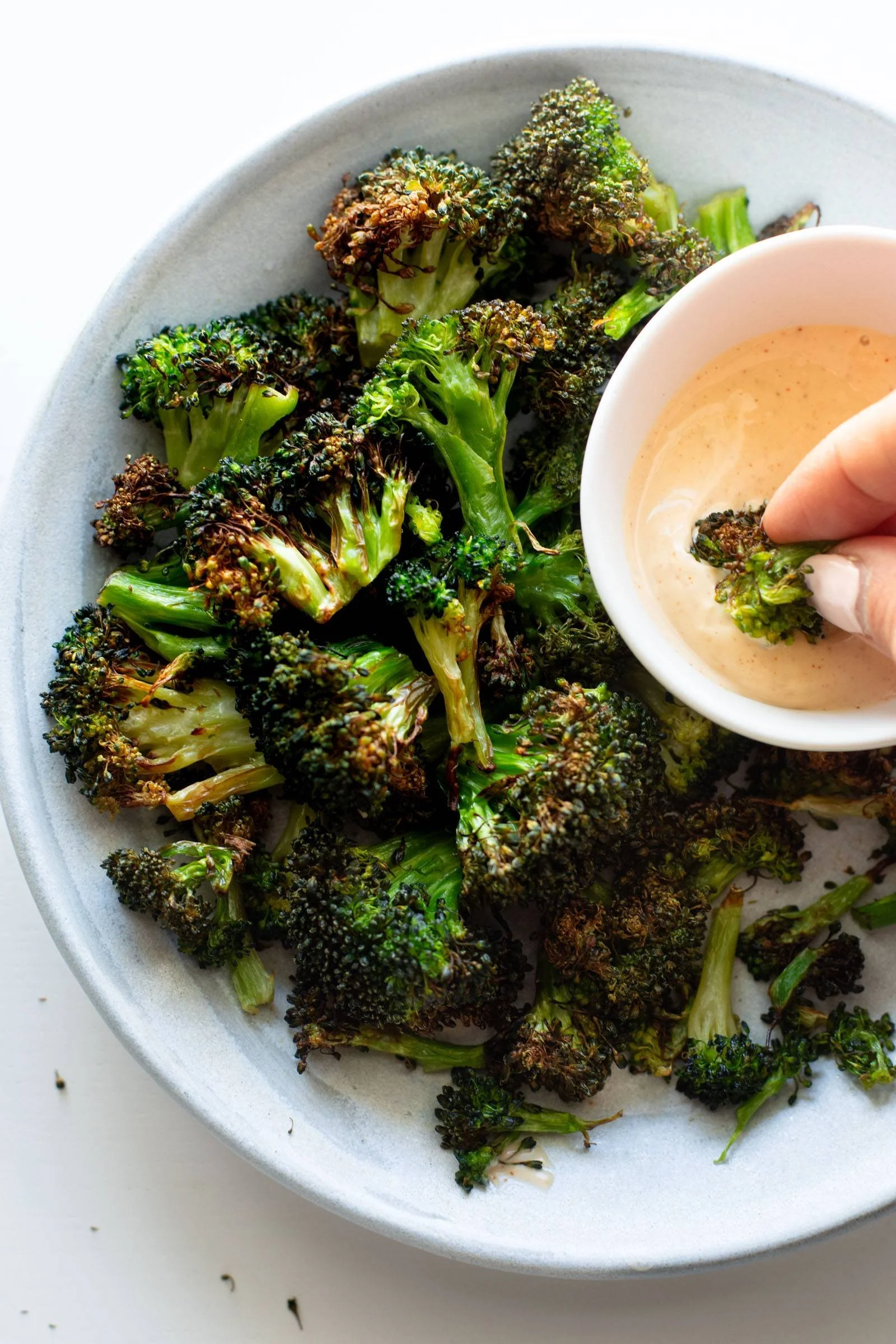 Crispy air fryer broccoli served in a bowl with seasoning