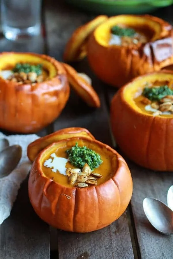 Bowl of Roasted Garlic Sage Pesto Pumpkin Soup garnished with herbs