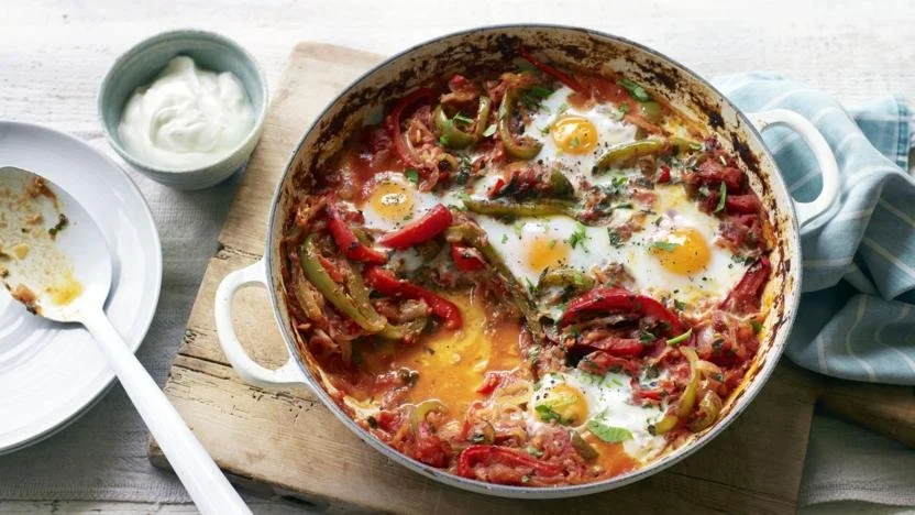 Delicious Shakshuka with poached eggs and vibrant tomato sauce served in a skillet