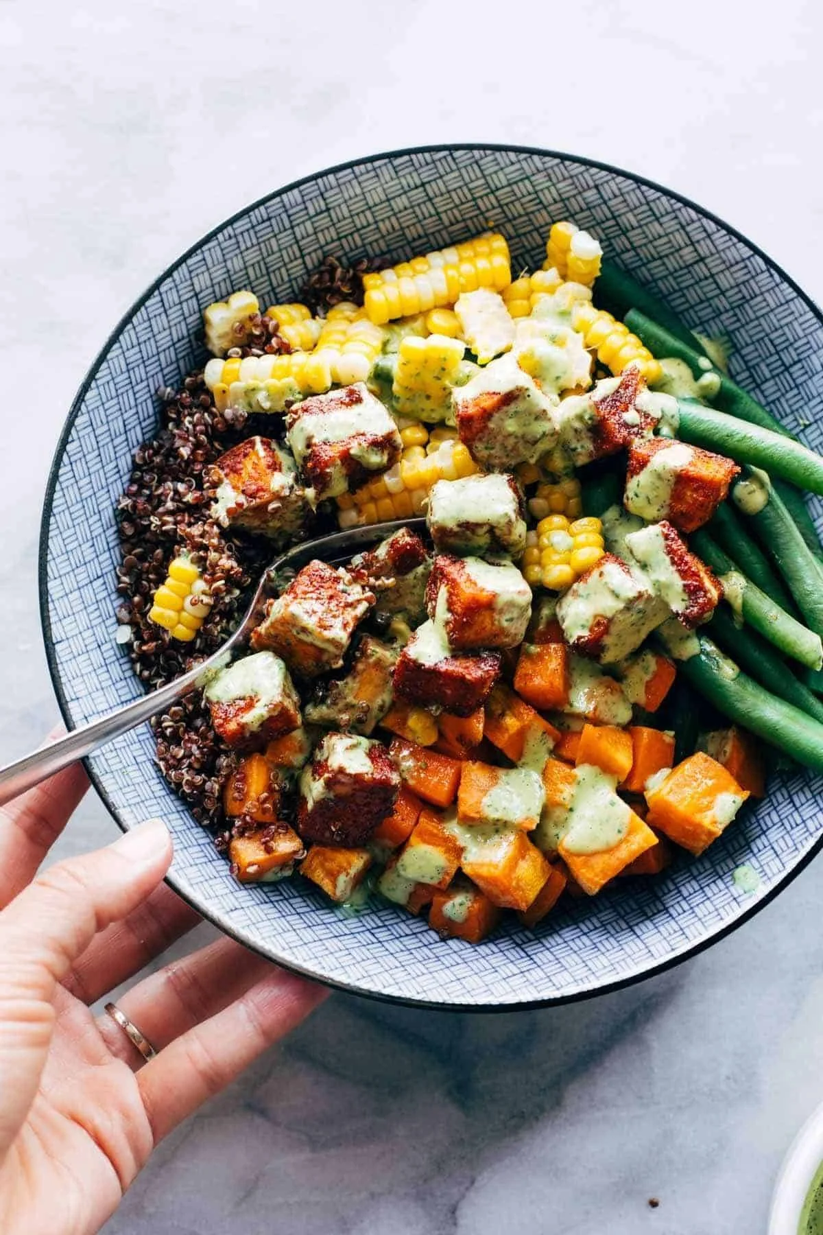 Sheet Pan BBQ Tofu served with fresh vegetables on a wooden table.