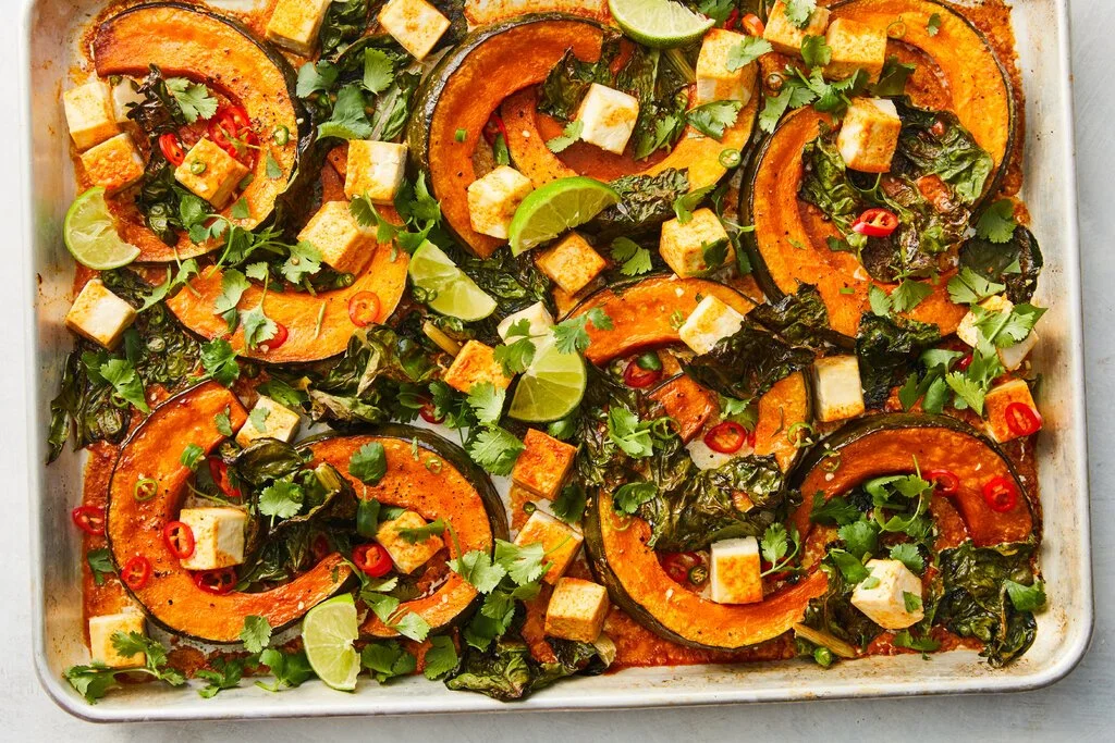 Sheet-pan coconut curry with squash and tofu served in a bowl.