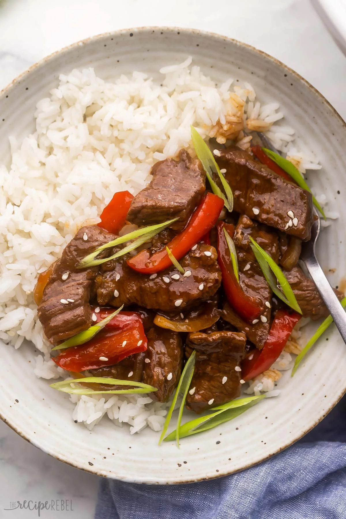 Slow Cooker Mongolian Beef served on a plate with vegetables.