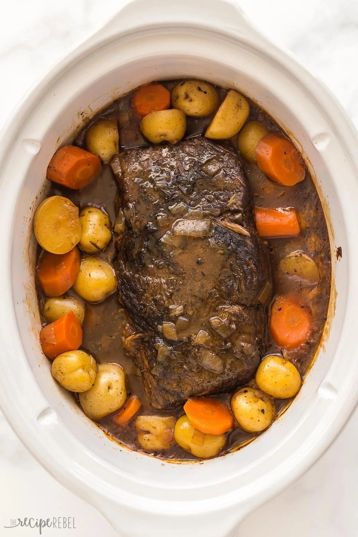 Slow cooker pot roast with rich gravy served on a plate