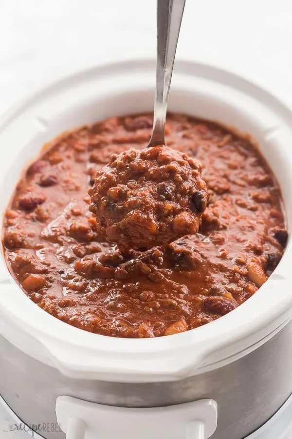 Delicious bowl of Slow Cooker Three Bean Beef Chili topped with fresh garnishes
