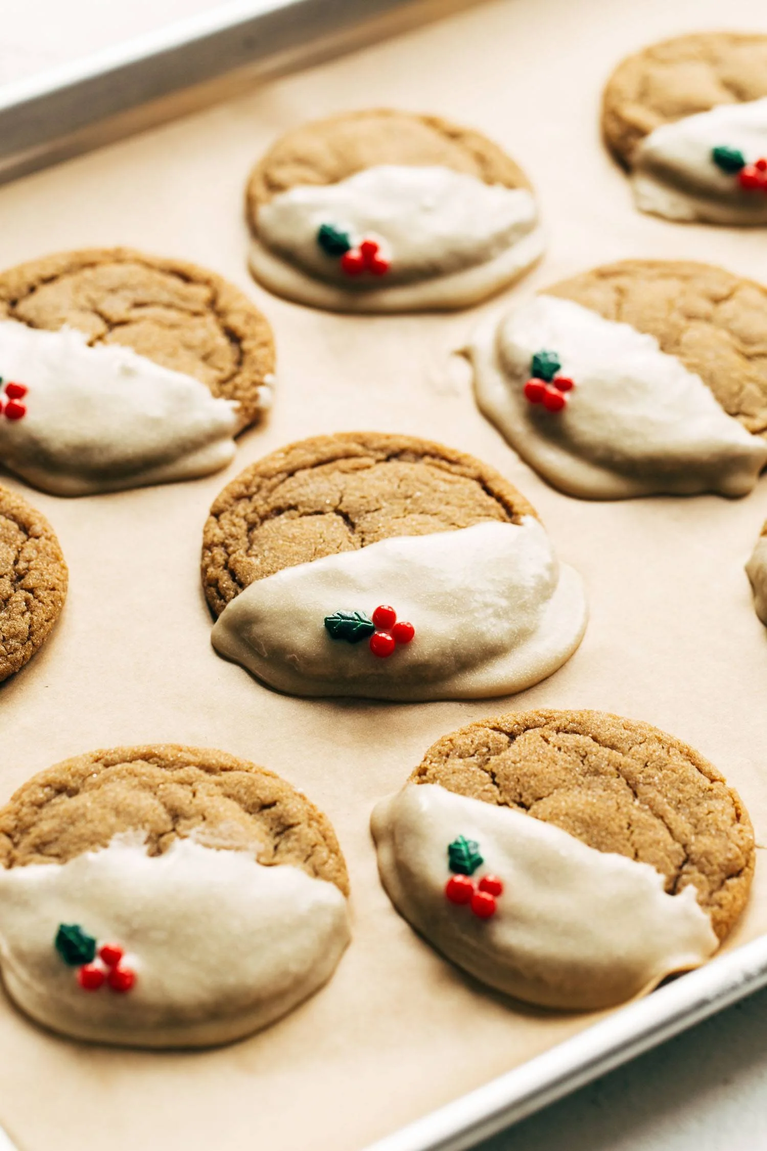Soft gingerbread cookies drizzled with maple glaze on a festive plate.