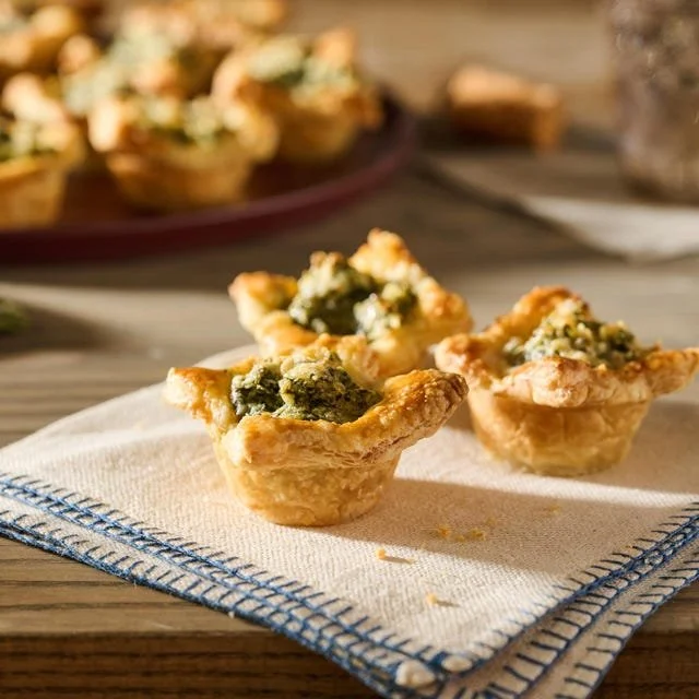 Delicious spinach puffs filled with creamy spinach and cheese on a platter