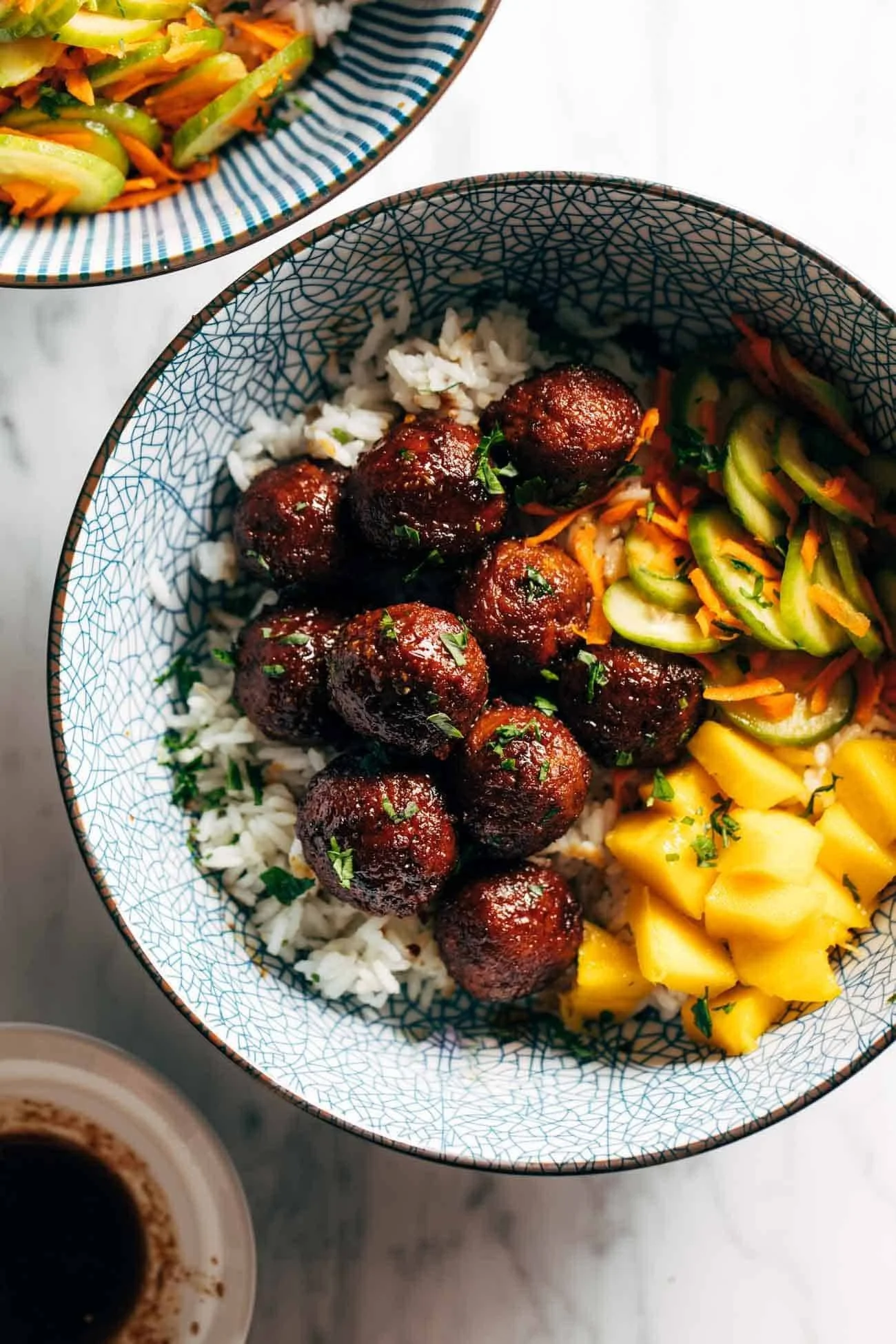 Delicious Sticky Ginger Rice Bowl garnished with fresh herbs and vegetables.