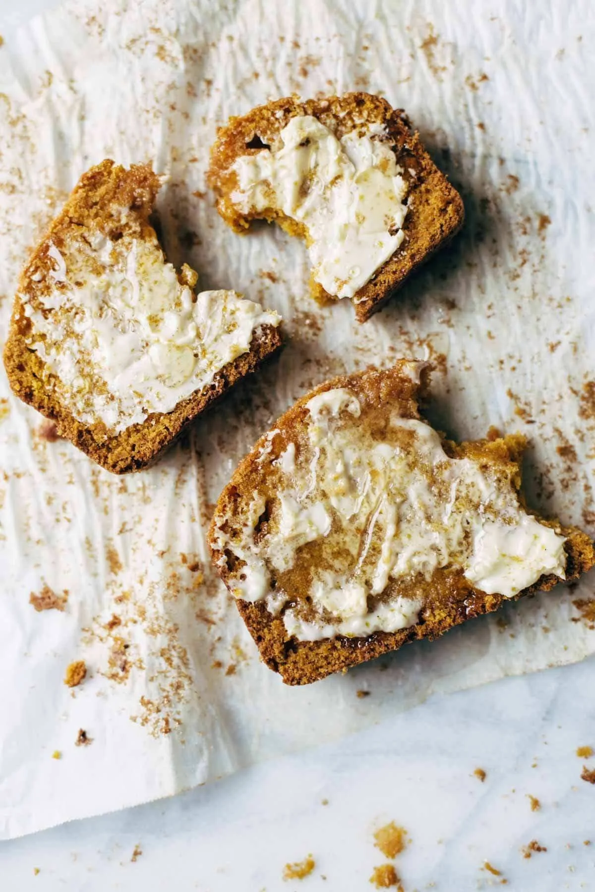Freshly baked super moist pumpkin bread slice on a wooden table