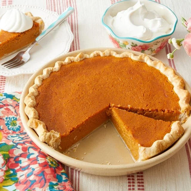 Delicious homemade sweet potato pie with whipped cream on top