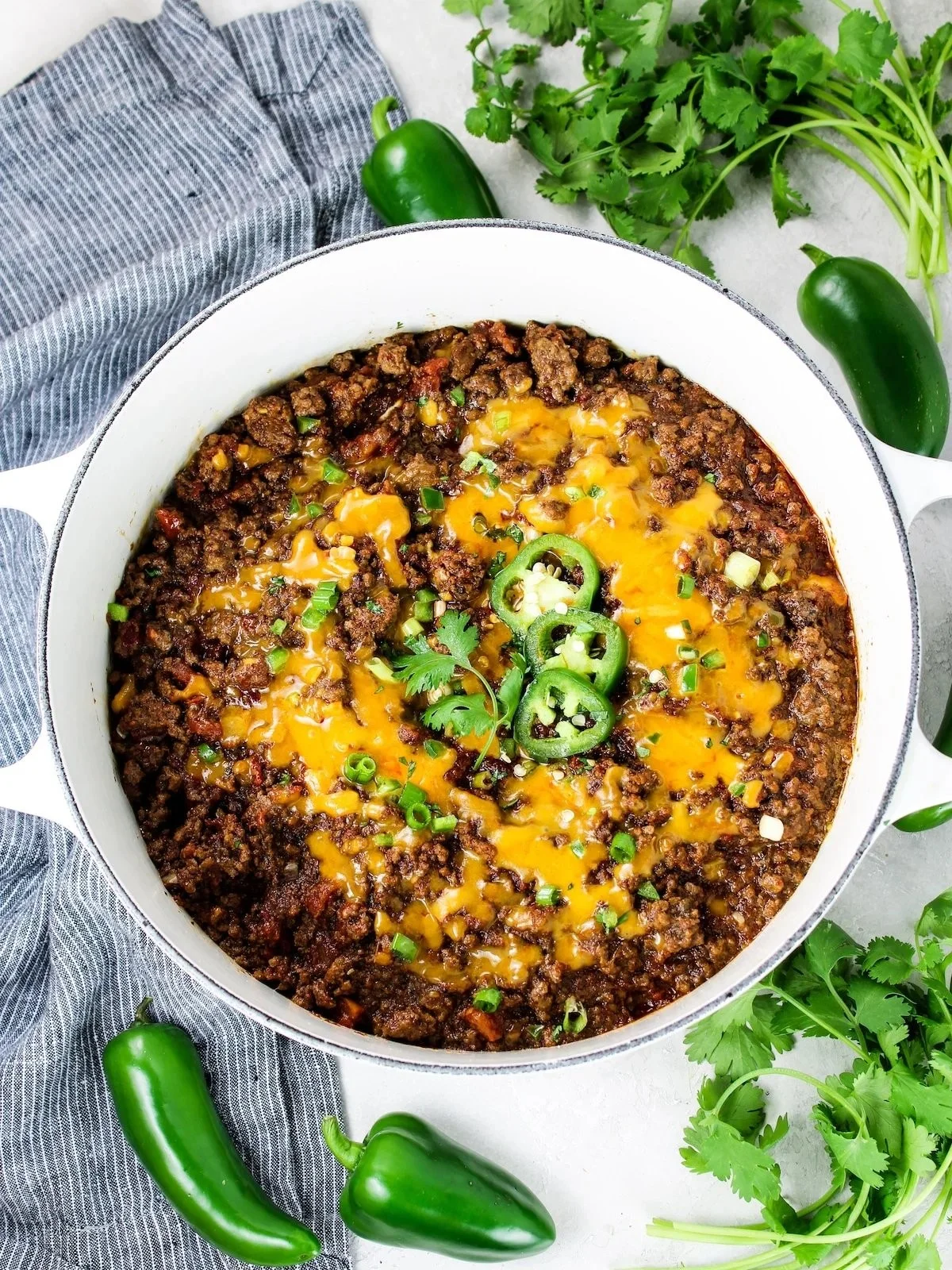 Bowl of hearty Texas-style chili topped with cheese and onions