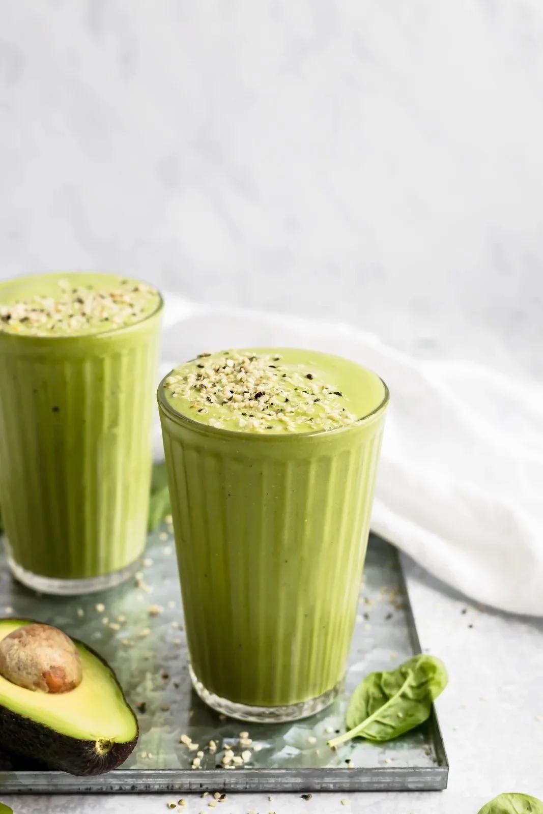 Delicious green smoothie in a glass with fresh ingredients