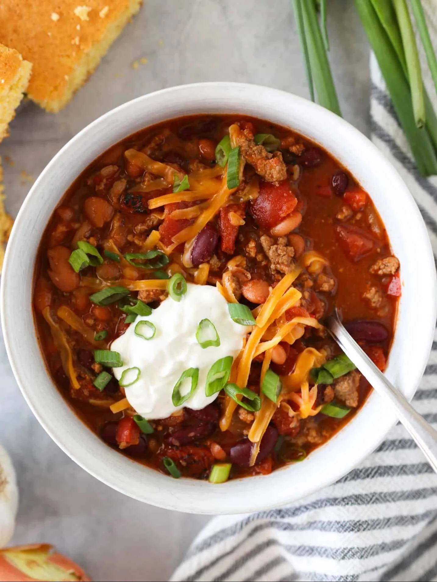Bowl of flavorful turkey chili topped with fresh herbs
