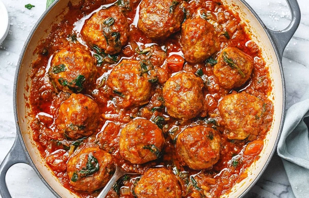 Plate of turkey-ricotta meatballs garnished with herbs