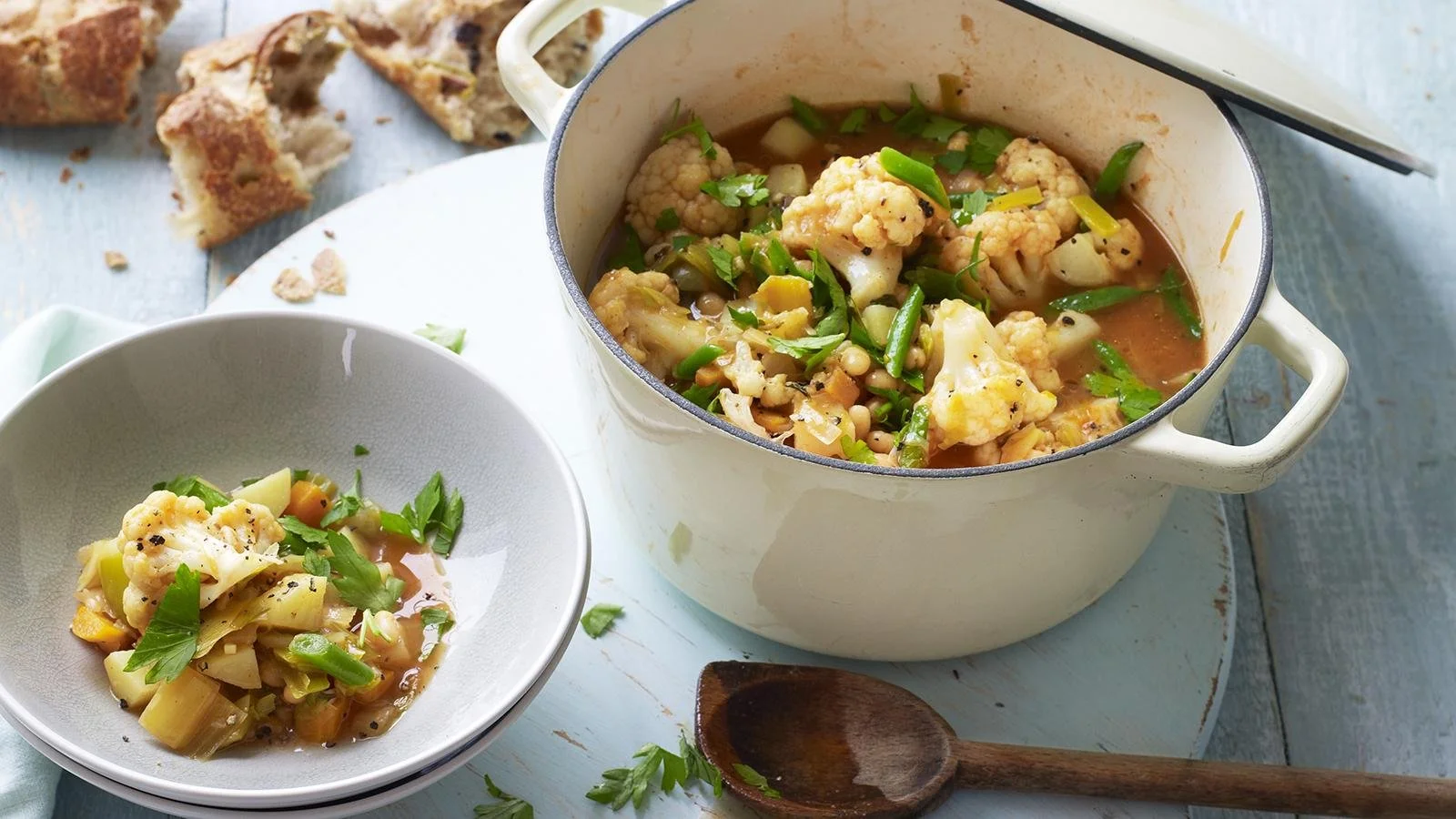 Bowl of versatile vegetable stew with fresh ingredients and herbs
