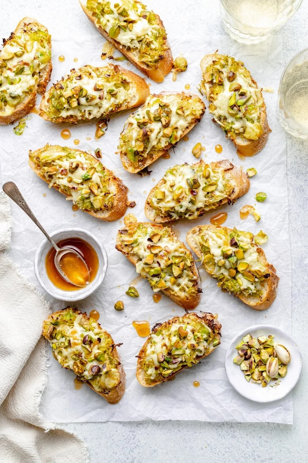 White Cheddar Brussels Sprouts and Pistachio Crostini with Hot Honey