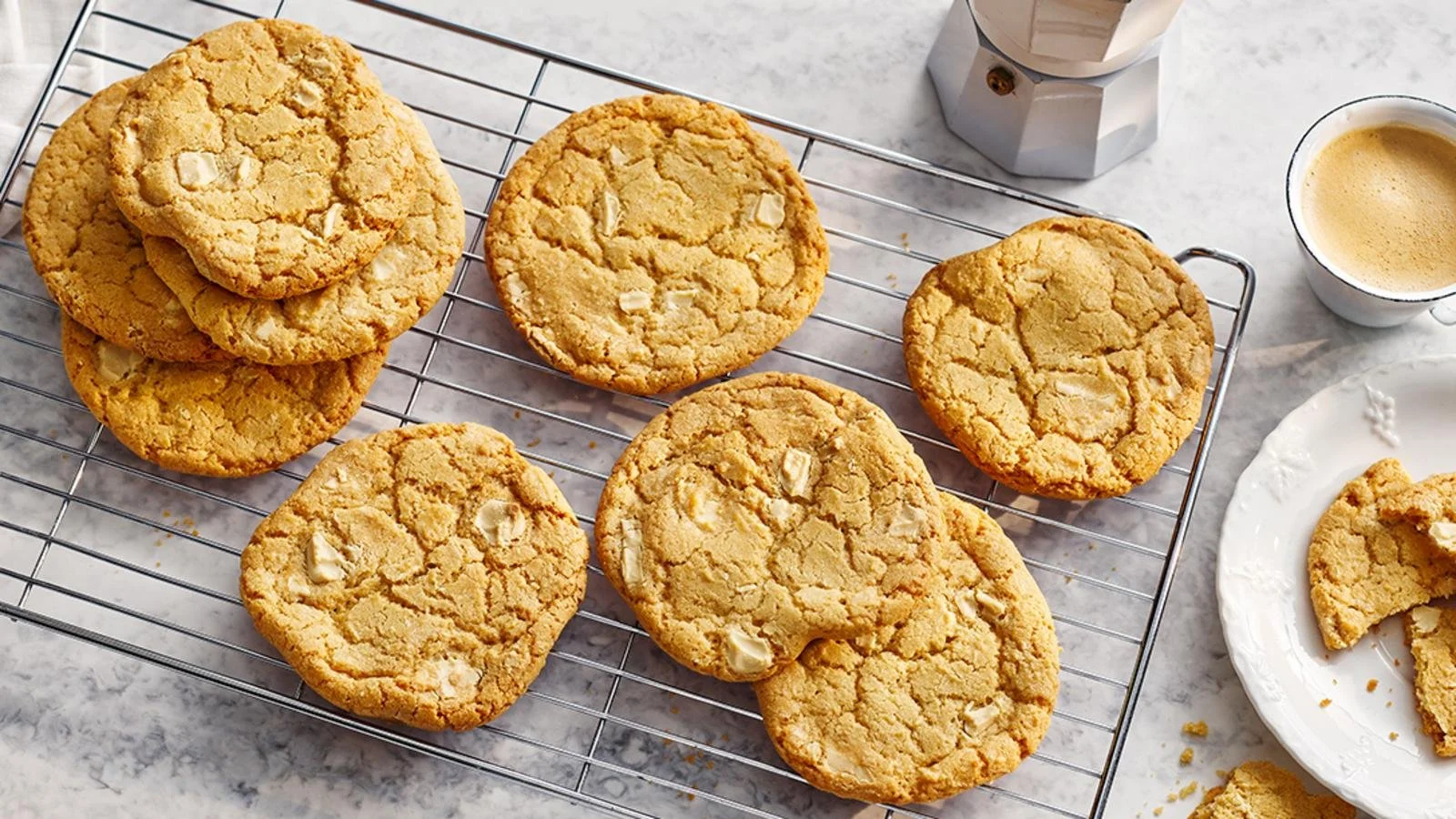 Delicious freshly baked white chocolate chip cookies on a cooling rack