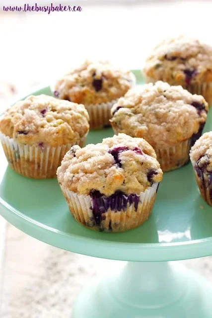Freshly baked zucchini blueberry muffins on a wooden table