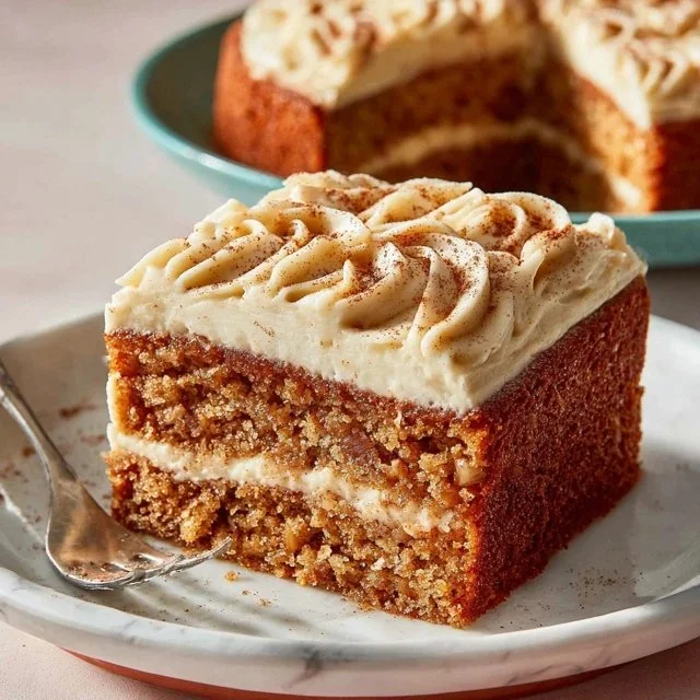 Applesauce cake with brown butter maple buttercream frosting on a plate