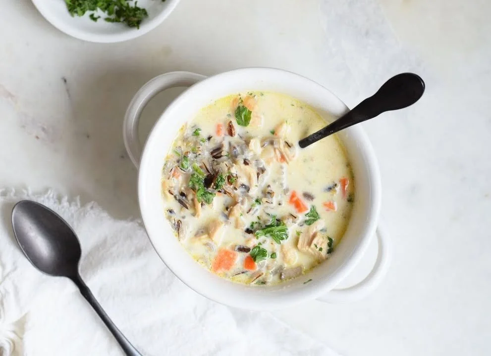 Bowl of Chicken and Wild Rice Soup garnished with herbs and spices