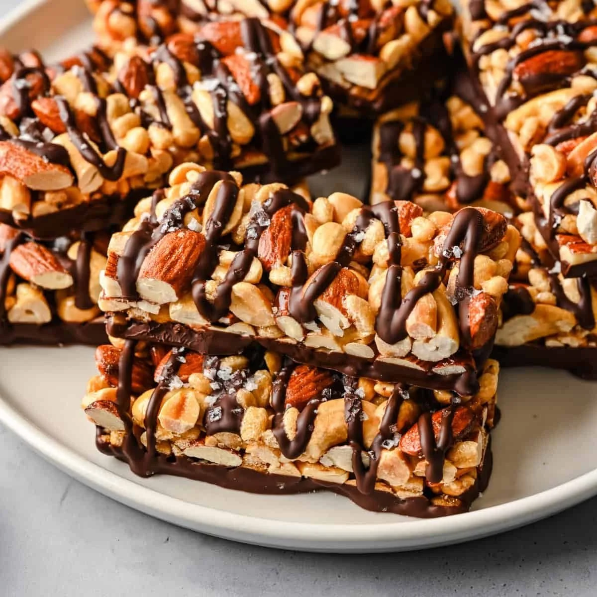 Dark chocolate and sea salt nut bars on a wooden table