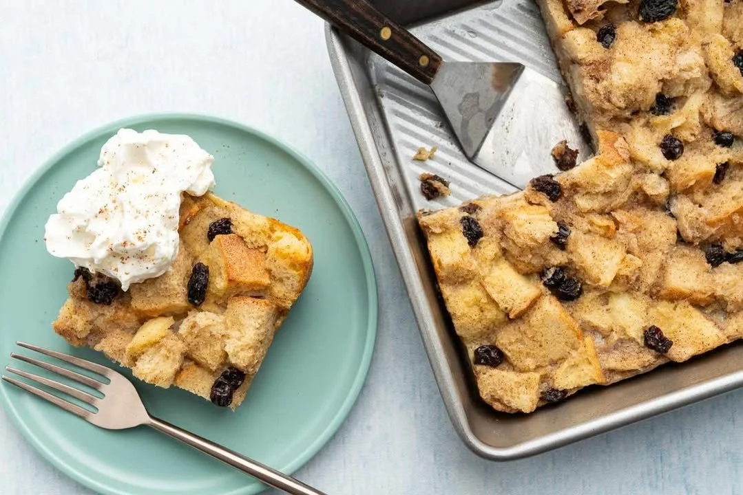 Delicious old-fashioned bread pudding dessert served warm with a drizzle of sauce