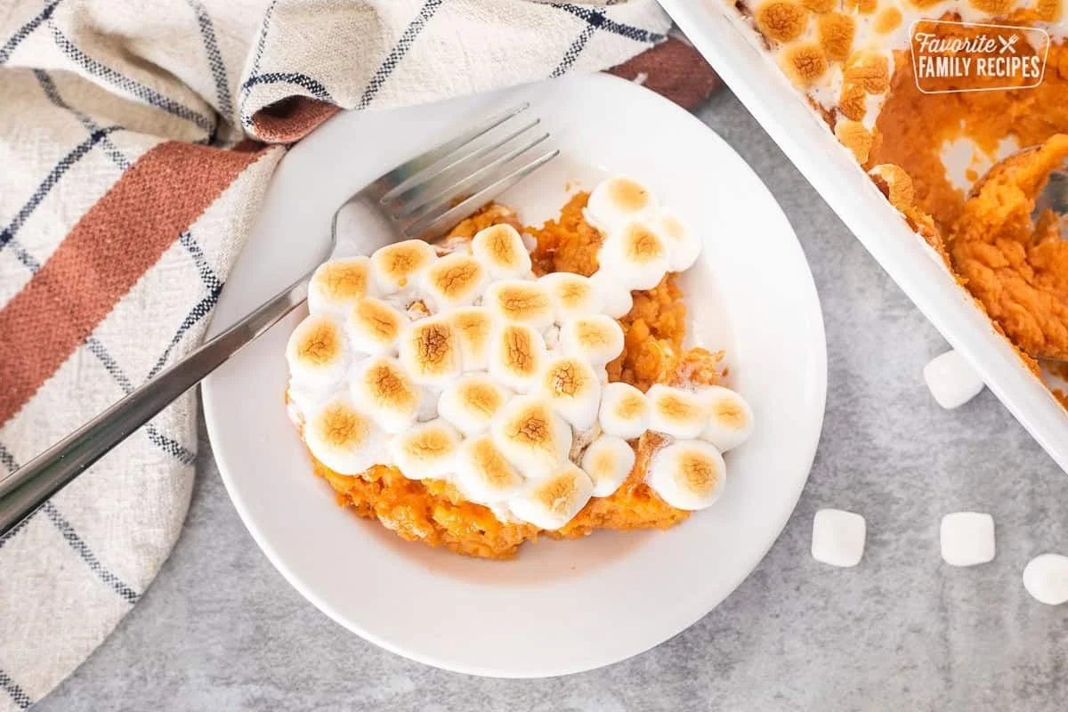 Baked sweet potatoes topped with melted marshmallows for a delicious dessert